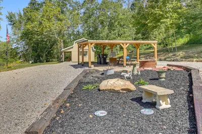 a park with a bench and a gazebo at On 40 Acres Charming Cabin in Zanesville! in Zanesville