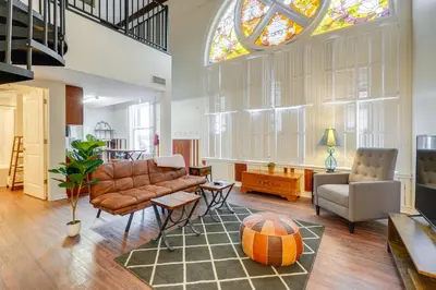 a living room with a couch and a window at Unique and Stylish Studio Loft in Huntington! in Huntington
