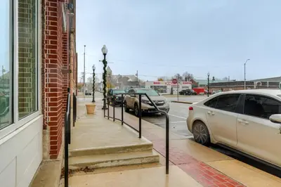 a sidewalk with cars parked on a city street at Unique and Stylish Studio Loft in Huntington! in Huntington
