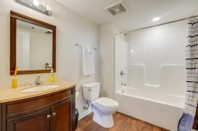 a bathroom with a toilet and a sink and a shower at Unique and Stylish Studio Loft in Huntington! in Huntington