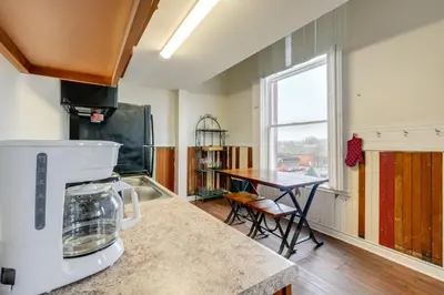a kitchen with a counter with a mixer and a table at Unique and Stylish Studio Loft in Huntington! in Huntington