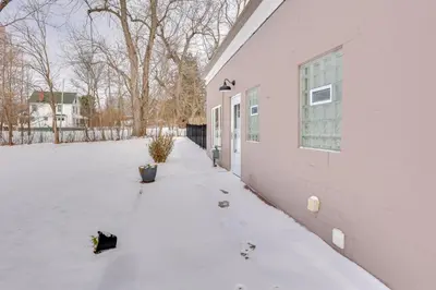 two cats sitting outside of a building in the snow at 3 Mi to Dtwn and YSU Updated Youngstown Home in Youngstown