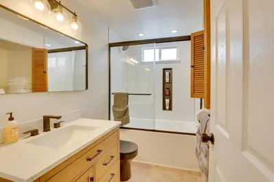 a bathroom with a sink and a mirror at 3 Mi to Dtwn and YSU Updated Youngstown Home in Youngstown