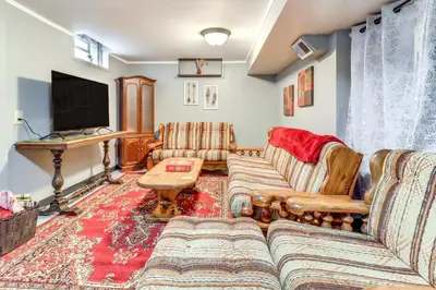 a living room with couches and a television at Walk to Adrian College Family Home in Michigan in Adrian
