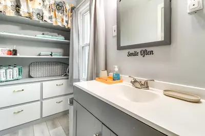 a bathroom with a sink and a mirror at Walk to Adrian College Family Home in Michigan in Adrian