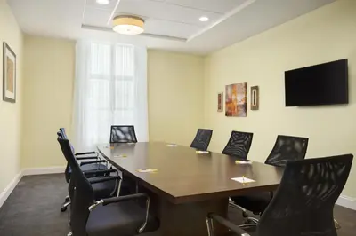 a conference room with a table and chairs at Days Inn & Suites by Wyndham Belmont in Belmont