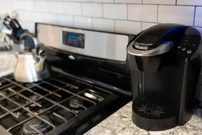 a coffee maker sitting on a counter next to a stove at Italian Village Gem, Downtown, Free Parking, OSU in Columbus