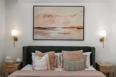 a bedroom with a bed with a painting on the wall at Italian Village Gem, Downtown, Free Parking, OSU in Columbus