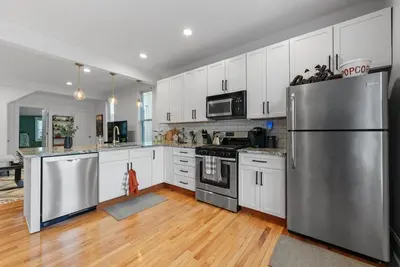 a kitchen with stainless steel appliances and white cabinets at Italian Village Gem, Downtown, Free Parking, OSU in Columbus
