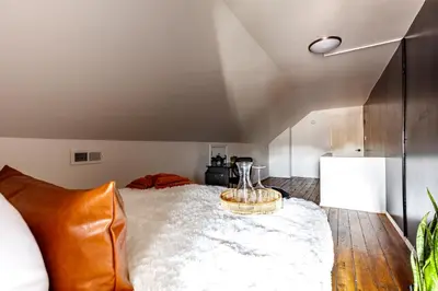 a bedroom with a large bed with a table at Jungle House Columbus Downtown Free Parking Sleeps 8 - Near Convention Center & Nationwide Arena - 2BR Luxury Home - Pet Friendly Over 5,800 Five Star Stays in Columbus