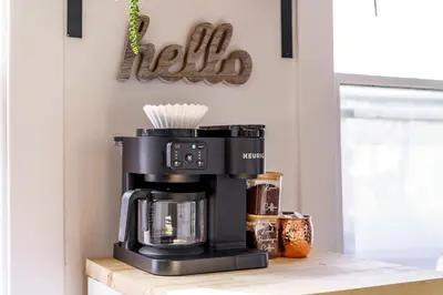 a black coffee maker on a counter in a kitchen at Jungle House Columbus Downtown Free Parking Sleeps 8 - Near Convention Center & Nationwide Arena - 2BR Luxury Home - Pet Friendly Over 5,800 Five Star Stays in Columbus