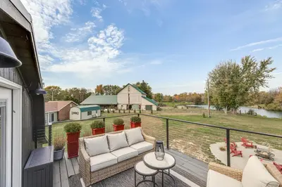 a patio with a couch and a table on a balcony at 5 Mi to WEC Pet-Friendly Home in Wilmington in Wilmington