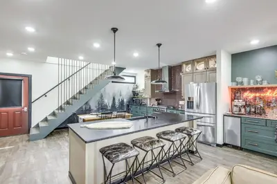 a kitchen with a large island with bar stools at 5 Mi to WEC Pet-Friendly Home in Wilmington in Wilmington