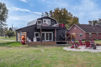 a black house with a deck and a house at 5 Mi to WEC Pet-Friendly Home in Wilmington in Wilmington