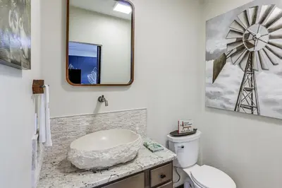 a bathroom with a white toilet and a large mirror at 5 Mi to WEC Pet-Friendly Home in Wilmington in Wilmington