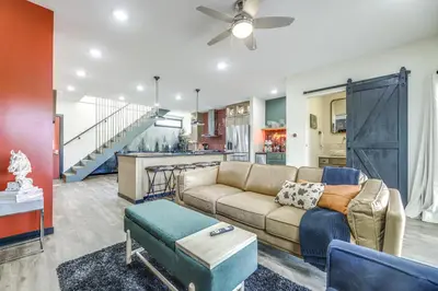 a living room with a couch and a kitchen at 5 Mi to WEC Pet-Friendly Home in Wilmington in Wilmington
