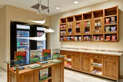 a store with wooden cabinets and a counter with food at Homewood Suites by Hilton Cincinnati-Downtown in Cincinnati