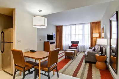 a living room with a dining table and a living room at Homewood Suites by Hilton Cincinnati-Downtown in Cincinnati
