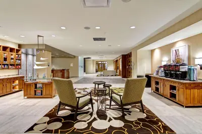 a large kitchen with a table and two chairs at Homewood Suites by Hilton Cincinnati-Downtown in Cincinnati