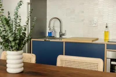 a kitchen with a wooden table with a vase on it at Lux Condo Steps to Washington Park - Walk to ALL in Cincinnati