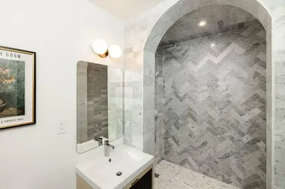a bathroom with a sink and a shower at Lux Condo Near Washington Park - Walk Everywhere in Cincinnati