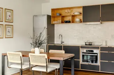 a kitchen with a wooden table and chairs in a kitchen at Lux Condo Near Washington Park - Walk Everywhere in Cincinnati