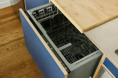 an empty dish rack in a dishwasher in a kitchen at Lux Condo Near Washington Park - Walk Everywhere in Cincinnati