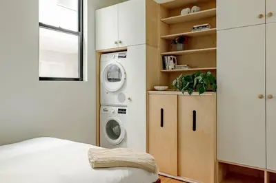 a laundry room with a washer and dryer in it at Lux Condo Near Washington Park - Walk Everywhere in Cincinnati