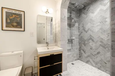 a bathroom with a sink and a toilet at Lux Condo Near Washington Park - Walk Everywhere in Cincinnati