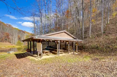 a gazebo on the side of a pond at Shared Pond and Trails Rosedale Cottage! in Rosedale