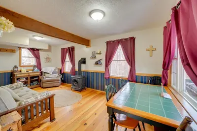 a living room with a table and a couch at Shared Pond at Retreat in Rosedale! in Rosedale