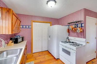 a kitchen with a stove and a white refrigerator at Picnics and Bonfires Rosedale Retreat! in Rosedale