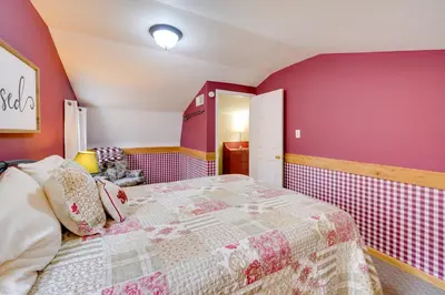 a bedroom with a bed with pink walls at Picnics and Bonfires Rosedale Retreat! in Rosedale