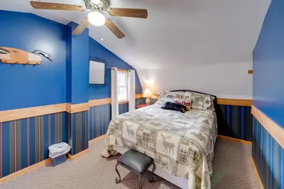 a blue bedroom with a bed and a ceiling fan at Picnics and Bonfires Rosedale Retreat! in Rosedale