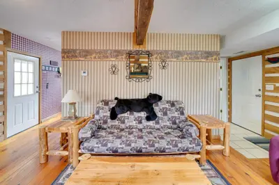 a dog sitting on a couch in a living room at Picnics and Bonfires Rosedale Retreat! in Rosedale