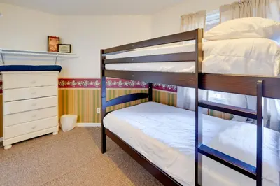 a bedroom with two bunk beds and a dresser at Hike and Picnic at Group Getaway in Rosedale! in Rosedale
