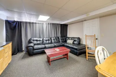 a living room with a leather couch and a table at Hike and Picnic at Group Getaway in Rosedale! in Rosedale