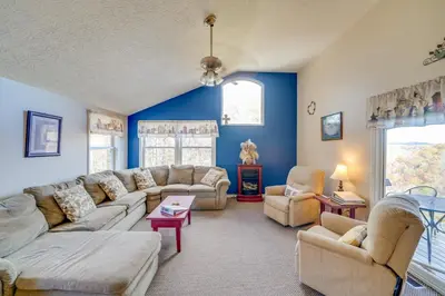 a living room with blue walls and couches at Hike and Picnic at Group Getaway in Rosedale! in Rosedale