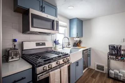 a kitchen with a stove and a microwave at Walkable to Everywhere in Little Italy- Near CWRU and Cleveland Clinic Main Campus in Cleveland