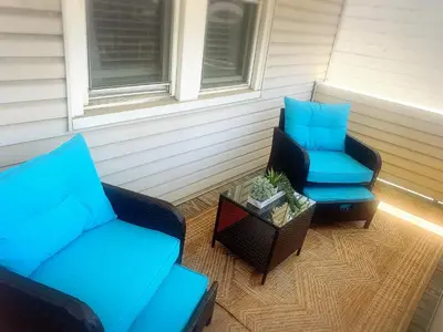 a patio with two chairs and a couch and a table at Walkable to Everywhere in Little Italy- Near CWRU and Cleveland Clinic Main Campus in Cleveland