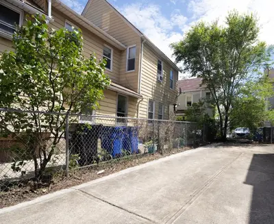 a fence in front of a house next to a street at Walkable to Everywhere in Little Italy- Near CWRU and Cleveland Clinic Main Campus in Cleveland