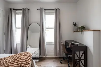 a bedroom with a bed and a desk and a mirror at Walkable to Everywhere in Little Italy- Near CWRU and Cleveland Clinic Main Campus in Cleveland