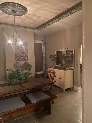 a dining room with a table and a cabinet at Charming Wheeling Island Home in Wheeling