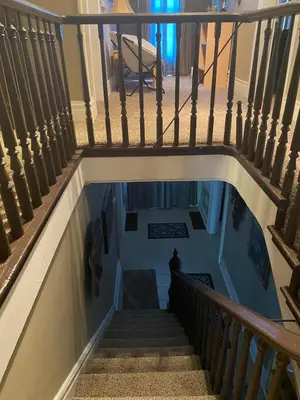 a stairway with a person standing in the water at Charming Wheeling Island Home in Wheeling