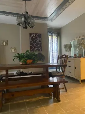 a dining room with a wooden table and a chair at Charming Wheeling Island Home in Wheeling