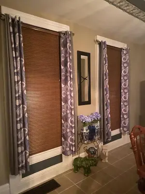 a room with two windows with purple curtains at Charming Wheeling Island Home in Wheeling
