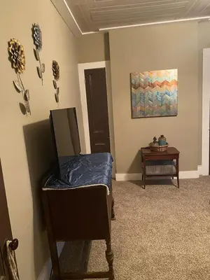 a room with a bed and a table at Charming Wheeling Island Home in Wheeling