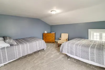 a bedroom with two beds and a dresser at 1 Block to Downtown Adrian Spacious Home! in Adrian