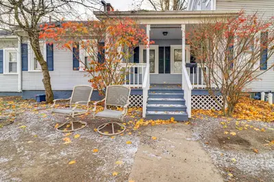 two chairs sitting in front of a house at 1 Block to Downtown Adrian Spacious Home! in Adrian