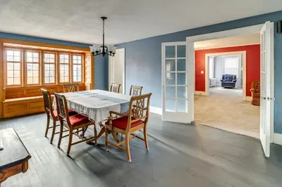 a dining room with a table and chairs at 1 Block to Downtown Adrian Spacious Home! in Adrian